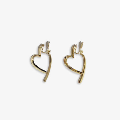 Subtle Sparkle for VSCO girl Style. Delicate silver heart clip-on earrings with a minimalist design.  Alloy construction and comfortable coil closure. Add a touch of romantic flair to your everyday look. 