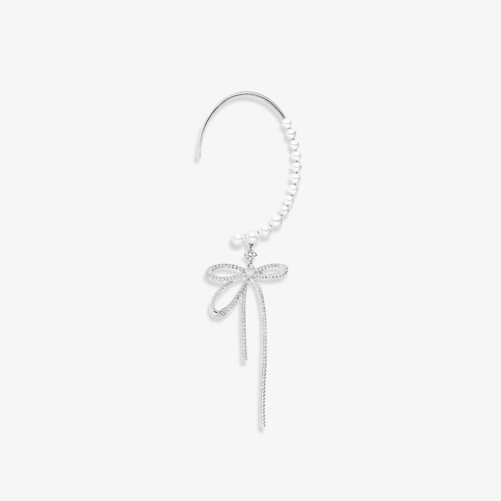 Elegant silver-tone bow and pearls ear wrap cuff earring with faux pearls and sparkling zircon accents. This classic style cuff is a sophisticated accessory for weddings and formal events, adding a touch of refined glamour without the need for pierced ears.