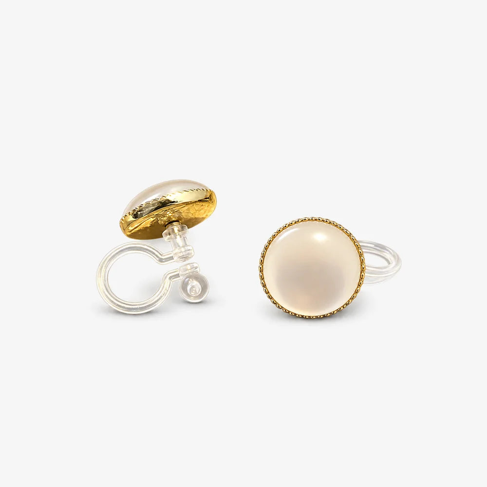 A close-up of the Lumi Frosted Moonstone invisible clip-on earrings, highlighting the luminous stone and the clear, comfortable clip mechanism.