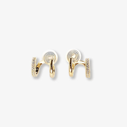 Elegant gold-toned double hoop clip-on earrings, adorned with sparkling zircon accents, feature a unique two-tone design. Fashioned from durable alloy and secured with coil clip-ons for ease of wear, these huggie-style earrings are a modern addition to any jewelry collection.