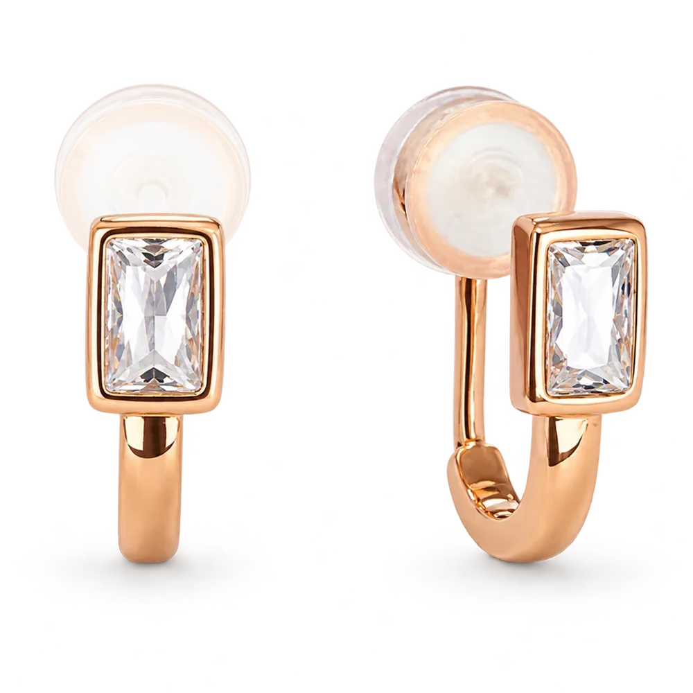 A pair of rose gold huggie hoop earrings with rectangular bezel-set clear crystals and silicon pad clip backings, shown on a clean white background.