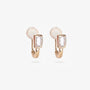 Detailed close-up of gold clip-on earrings with emerald-cut center stone and baguette cubic zirconia accents on a white background.