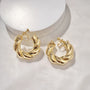 Bold Twist Hoop Clip On Earrings in Gold displayed on white background showing polished finish and twisted design detail