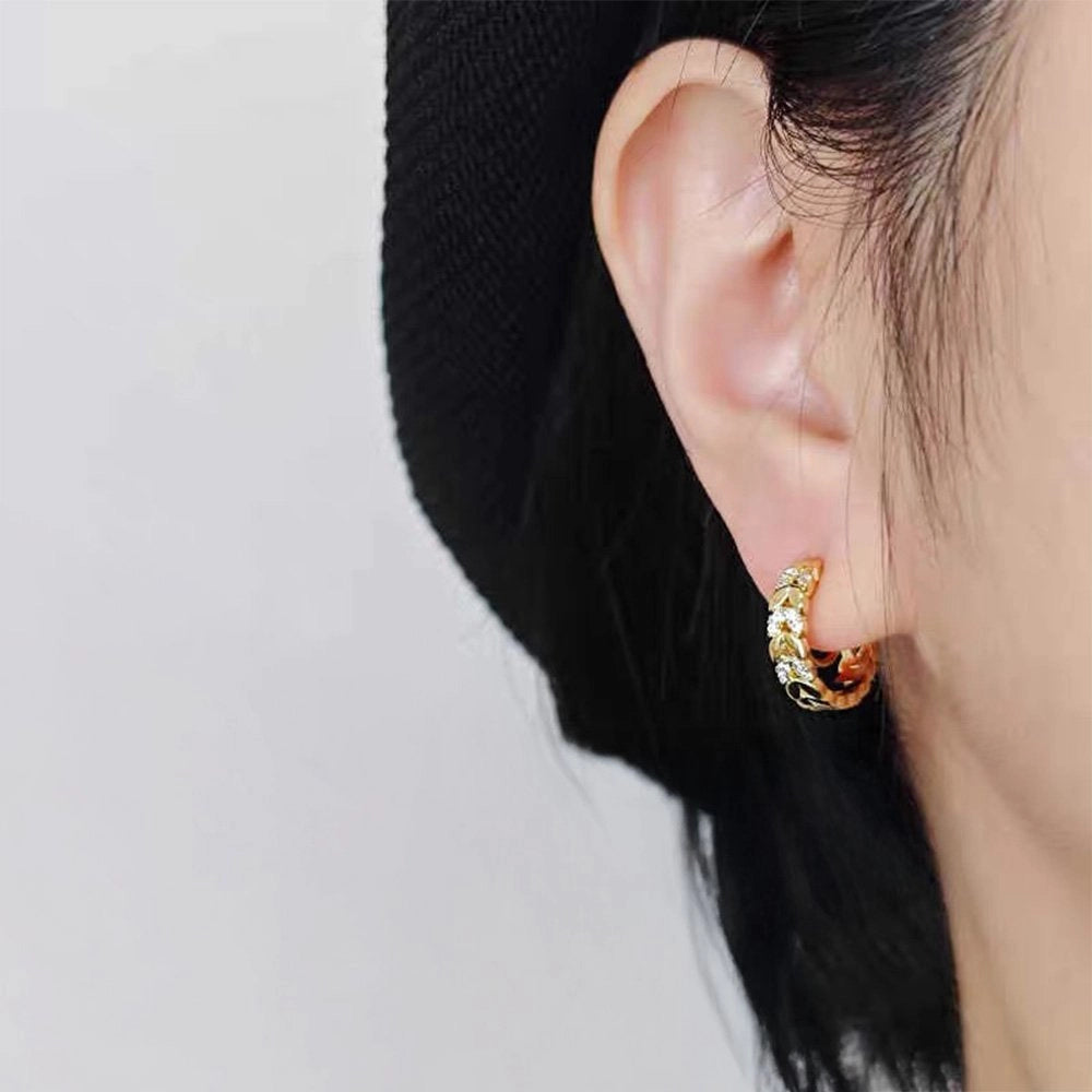 Gold Chain Zirconia Clip-On Hoop Earrings worn on a model's ear, close-up