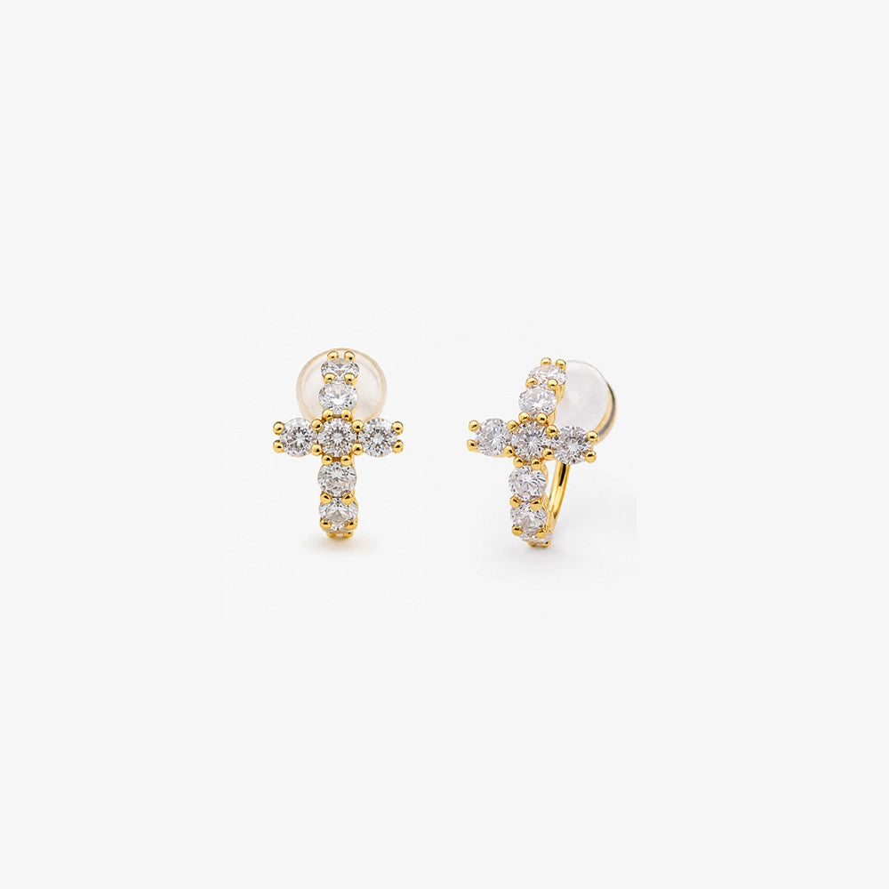 Gold cubic zirconia cross clip on huggie earrings shown as a pair from the front