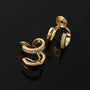Gold double hoop earrings with embedded stones on a black background