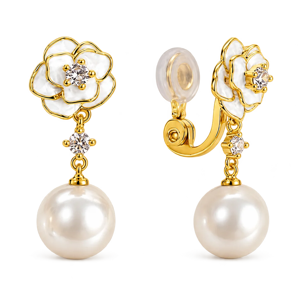 A pair of gold and pearl flower-shaped drop earrings with clear gemstone centers, shown on a clean white background. One earring is facing forward to show the flower and dangling pearl, while the other is angled to show the clip-back closure.