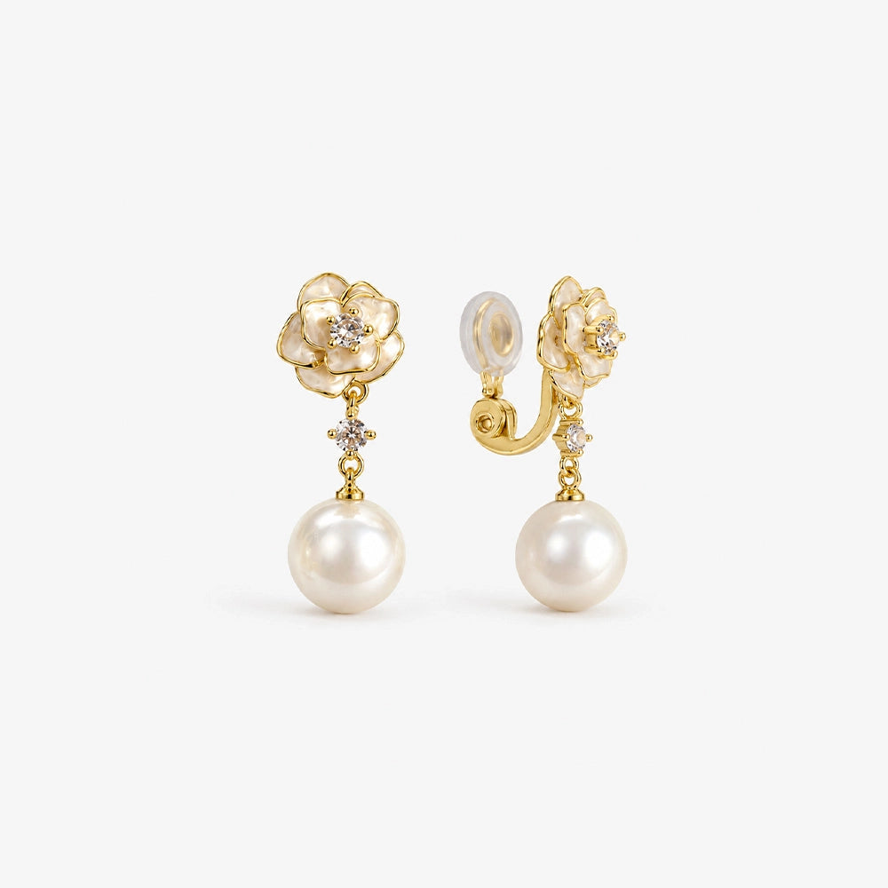 Pair of gold flower and shell pearl drop clip on earrings with white enamel petals
