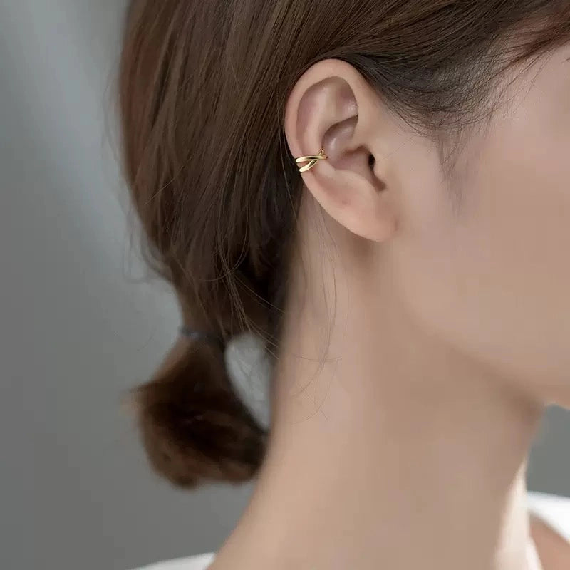 Gold Helix cross ear cuff in sterling silver worn on ear, side profile view 