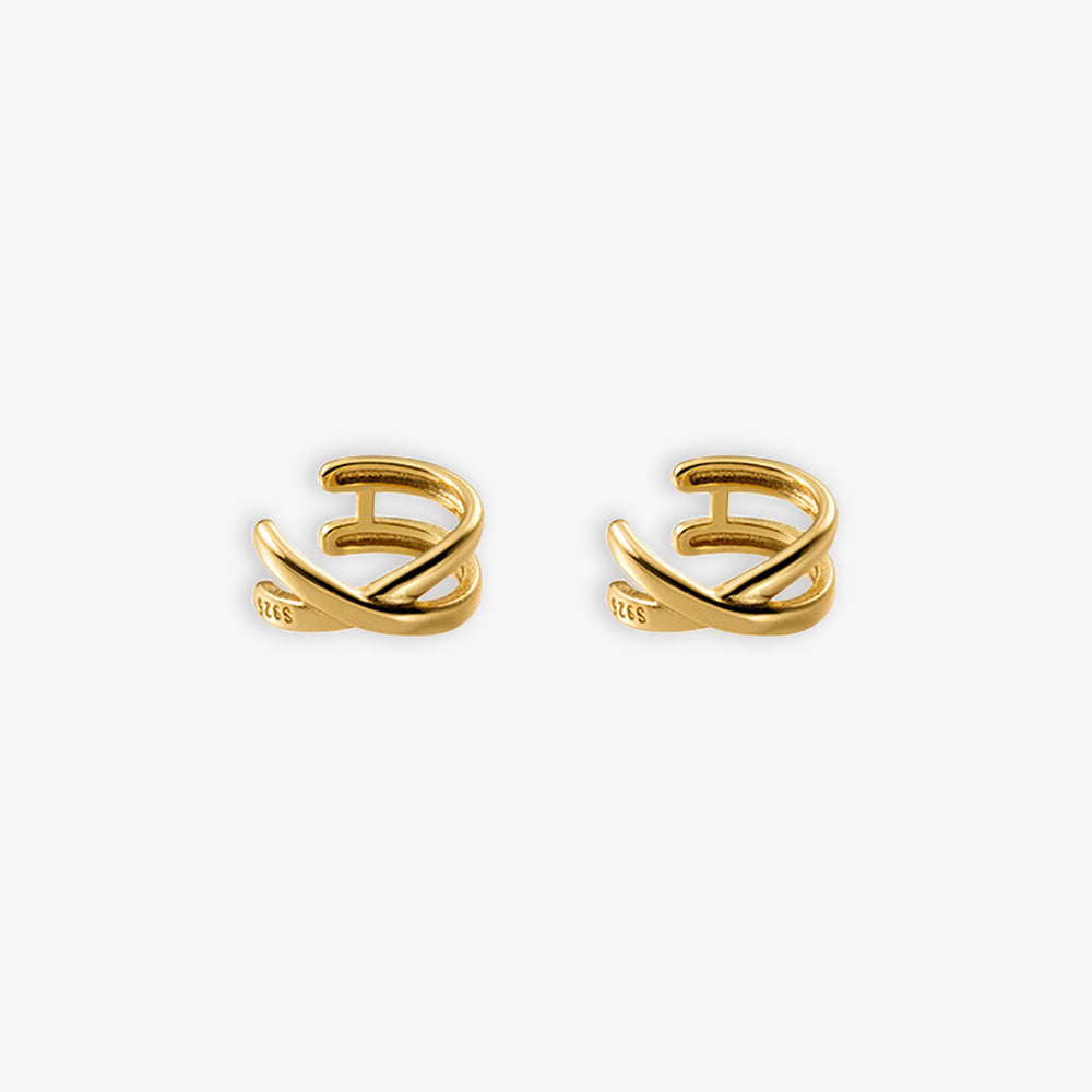 Two gold Helix Cross Ear Cuffs isolated on a white background, their S925 silver construction gleaming with a polished finish. These conch ear cuffs feature an elegant, twisting design suitable for daily wear, adding a modern and sophisticated touch to any outfit.