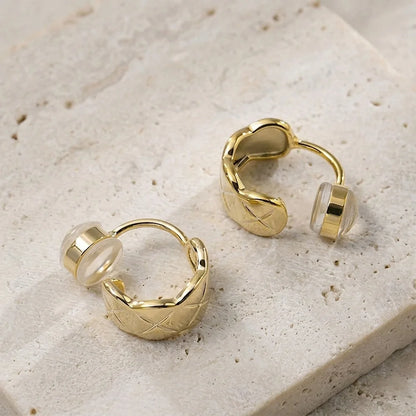 Close-up of gold lattice-etched clip on hoops showing the high-shine finish and comfort c-type clip on.