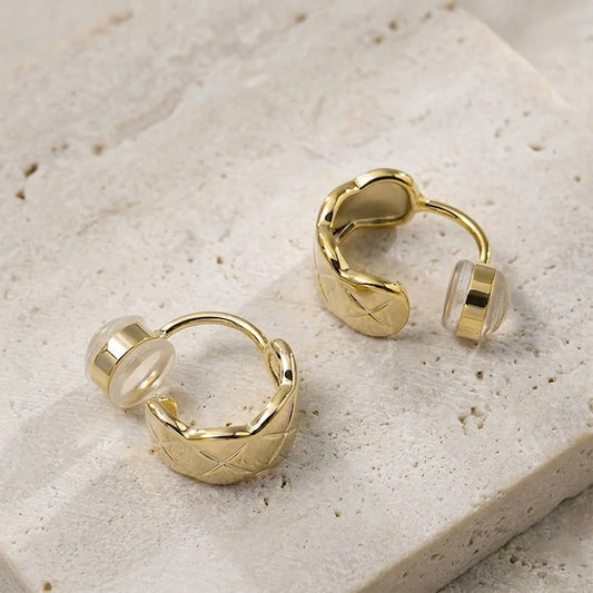 Close-up of gold lattice-etched clip on hoops showing the high-shine finish and comfort c-type clip on.