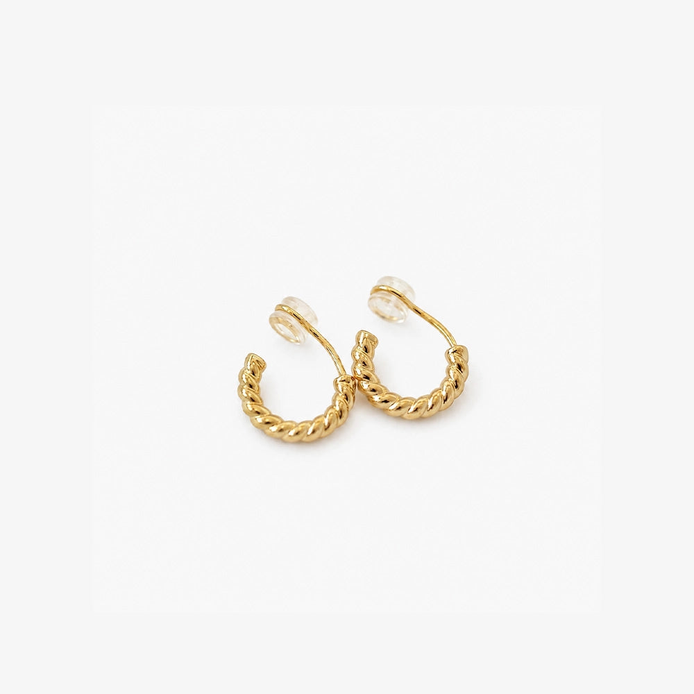 Gold twisted rope clip on hoop earrings showing the cushioned clip on closure