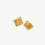 Close up detail of the woven basketweave pattern on gold clip on earrings