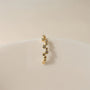 Detailed front view of the gold zircon cluster ear cuff, showcasing the arrangement of the sparkling stones.