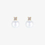 Pair of White Pearl Drop Clip-On Earrings in Gold Setting displayed on a soft beige surface, capturing the elegant design and color contrast.