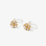 A pair of gold-toned stud earrings with a snowflake-like cluster of clear gemstones and a small white pearl, attached to clear silicone ear clip on, shown on a light gray background.