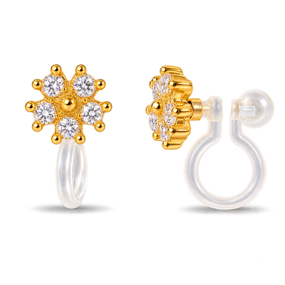 A pair of gold flower-shaped clip on earrings with clear gemstones, shown from the front and side on a clean white background.