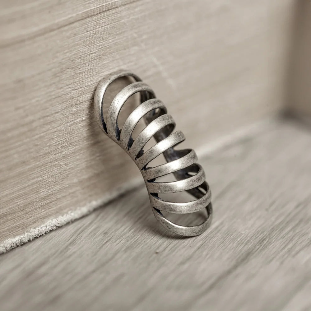 Silver Gothic Helix Ear Cuff angled side view on wooden surface, metallic finish