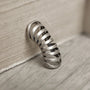 Silver Gothic Helix Ear Cuff angled side view on wooden surface, metallic finish