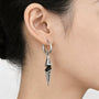 Gothic spike dangle clip-on earring worn on a non-pierced ear, looking like a pierced hoop