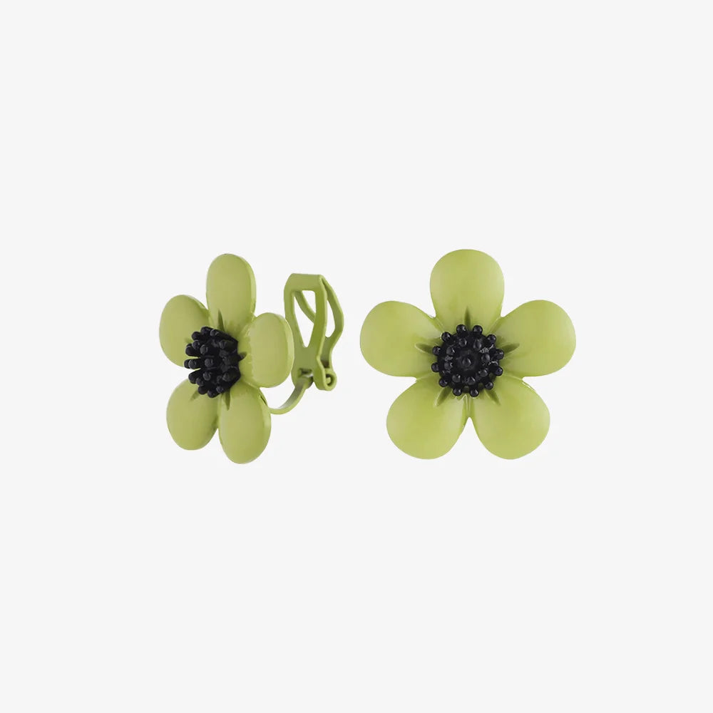 Lime Blossom clip-on earrings front and side view with pale green petals and black centers on white background