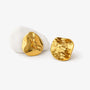 Close up detail of the hammered texture on gold disc clip on earrings