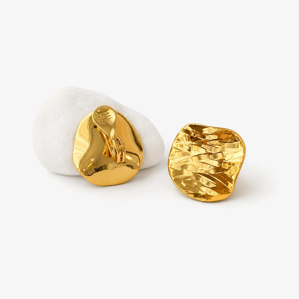 Close up detail of the hammered texture on gold disc clip on earrings