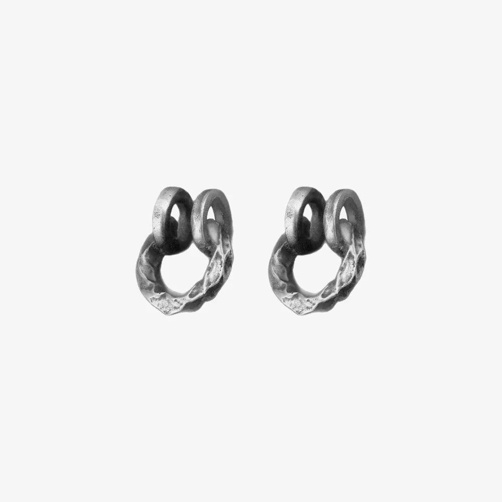 A single hammered oxidized silver clip-on ear cuff with a rustic, textured finish, shown isolated on a white background.