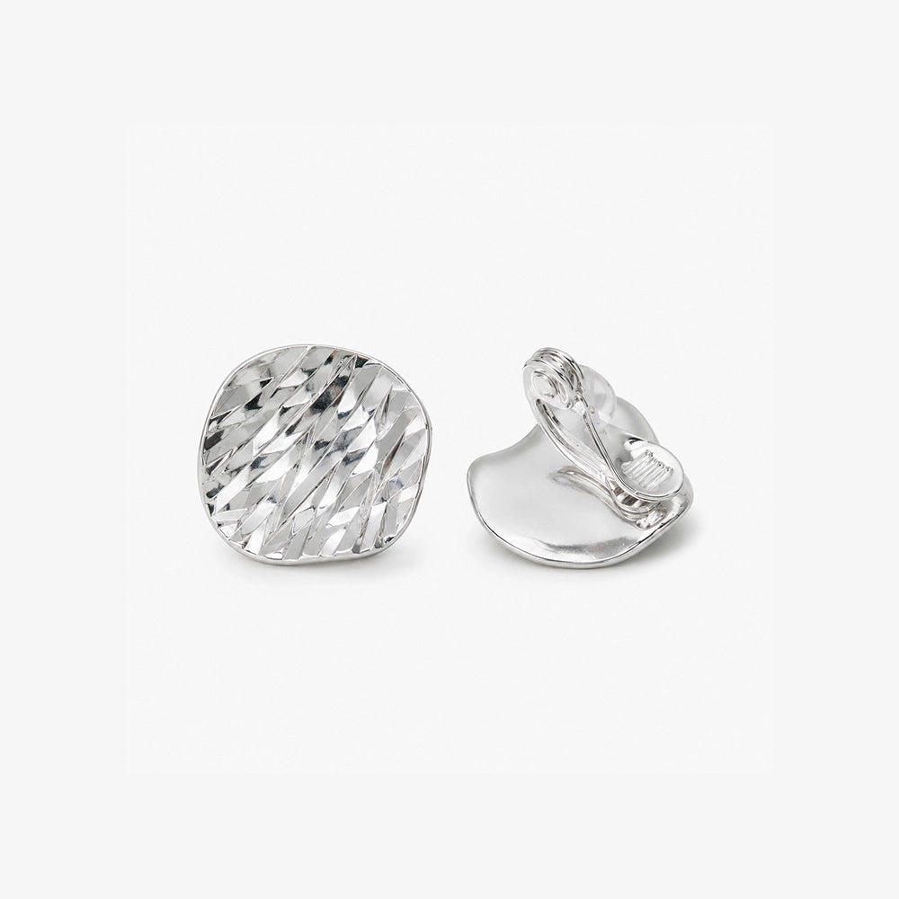 Hammered silver disc clip on earrings showing the adjustable clip on closure