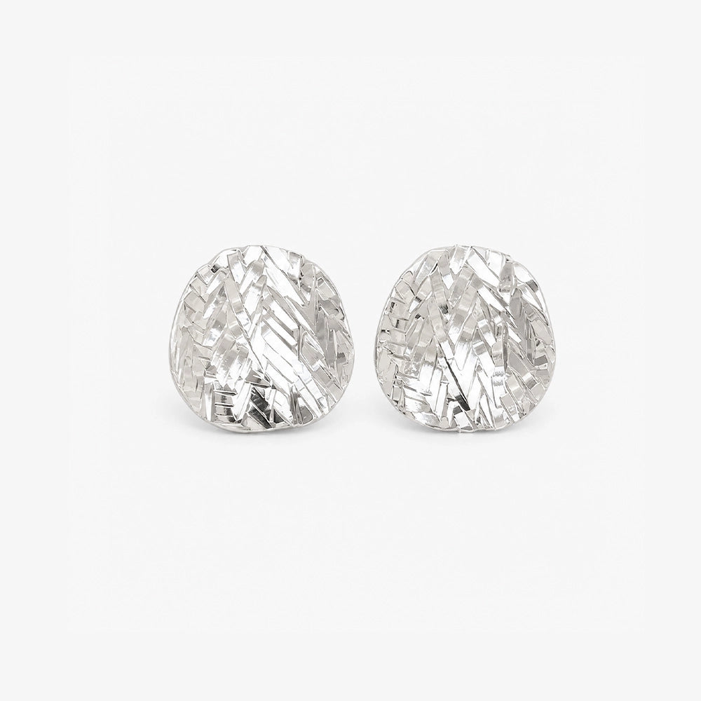 Pair of hammered silver disc clip on earrings with a domed textured finish