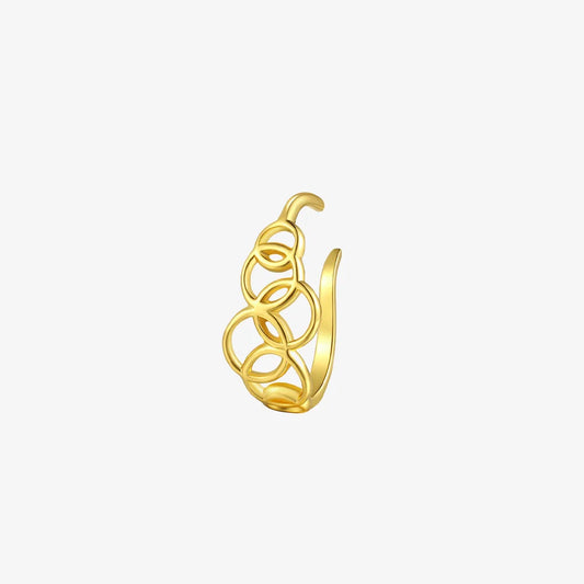 A sculptural gold lobe cuff with a geometric interlocking circle design, shown on a white background.