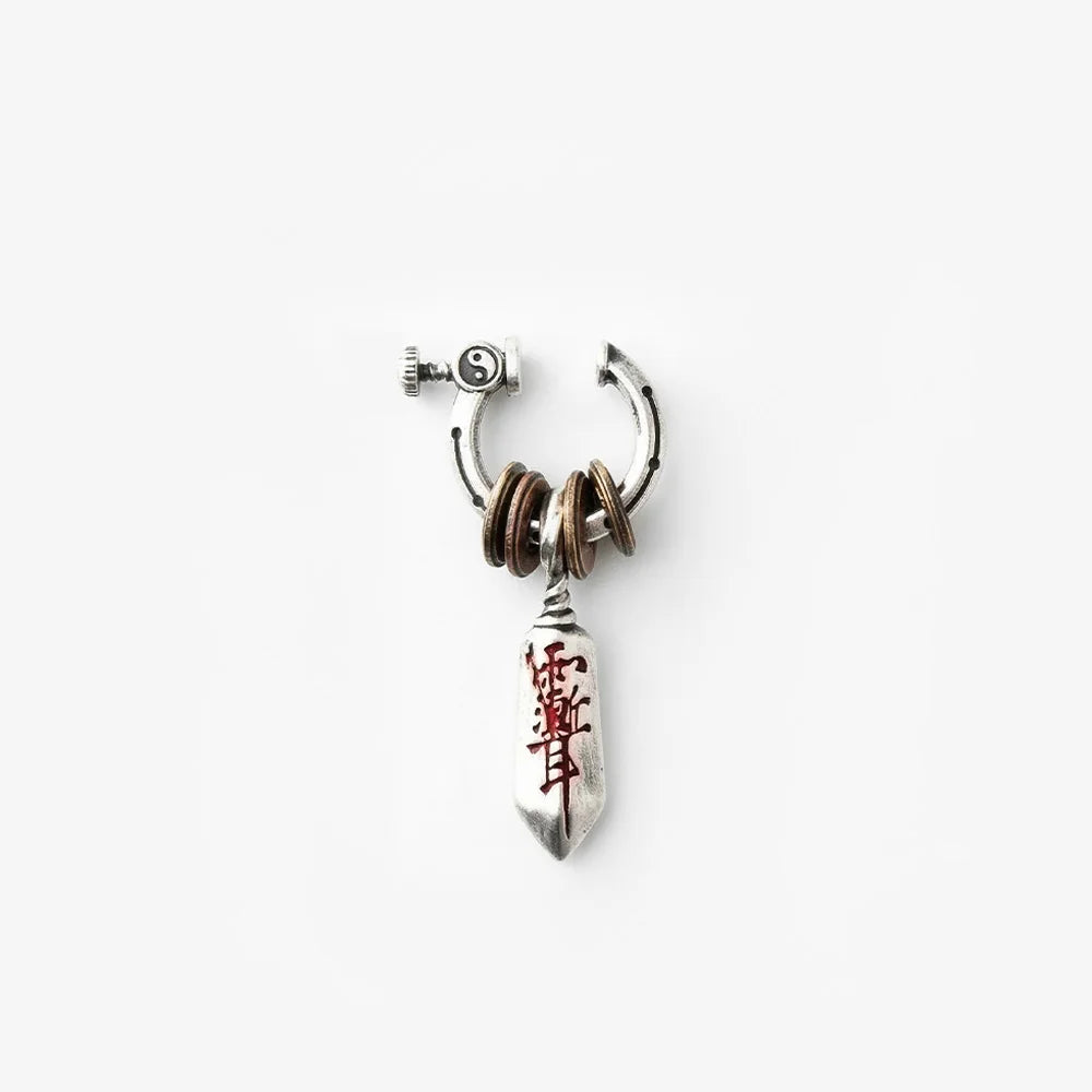 A full product shot of the complete Katana dagger single clip-on earring on a plain white background. The sterling silver hoop, stacked bronze coins, and dagger pendant are clearly displayed.