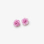 A pair of light pink rose stud earrings on a clean, solid off-white background.