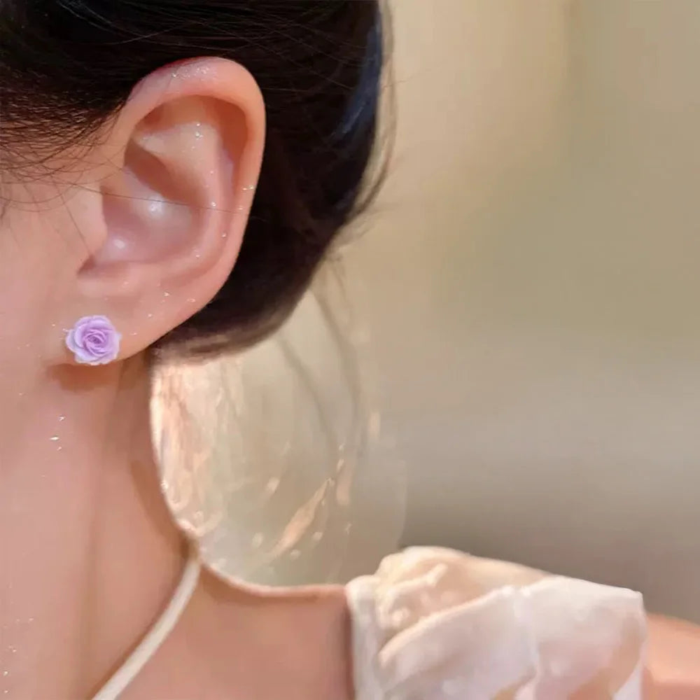 Lavender rose magnetic stud earring worn on ear