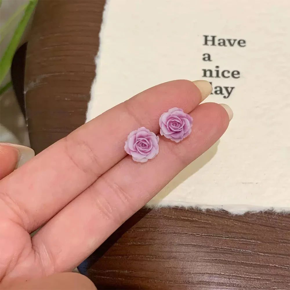 Showcase lavender rose magnetic clip‐on stud earring on hand.