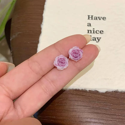 Showcase lavender rose magnetic clip‐on stud earring on hand.