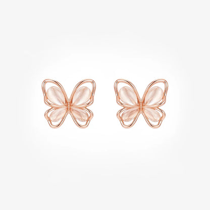 Front view of a pair of rose gold butterfly magnetic stud earrings with soft pink cat's eye wings on a white background.