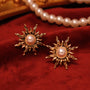 Sparkle like the stars with these charming gold sunburst clip-on earrings.  Adorned with luminous faux pearls, they capture the essence of the celestial trend.  The secure hinged back closure ensures a comfortable fit for non-pierced ears. 