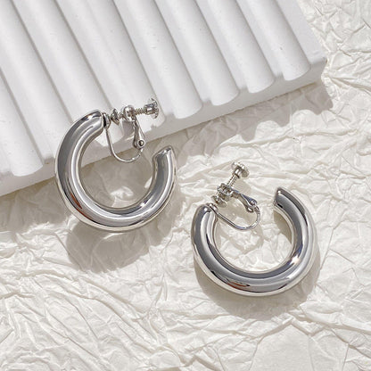 old silver alloy classic hoop clip-on earrings with a lustrous finish and screw-back closure, embodying strength and self-love in today's fashion trends.