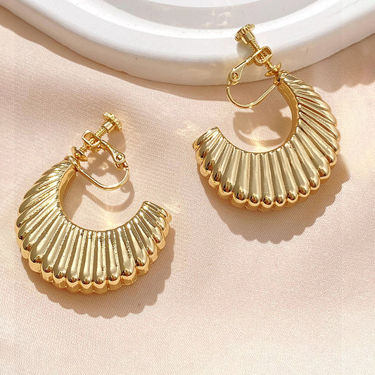 The Croissant Semi Hoop Clip-On Earrings exude Parisian elegance with their luxurious gold tone and bold, chunky design reminiscent of classic French pastries. They are crafted from high-quality alloy and secured with screw-back clips for non-pierced ears.