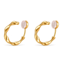 A pair of gold huggie hoop earrings with a smooth, organic wavy curve and a round pale pink stone set in each earring, shown on a plain white background.