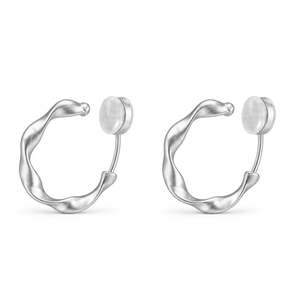 A pair of matte silver organic abstract clip-on hoop earrings with a soft satin finish.