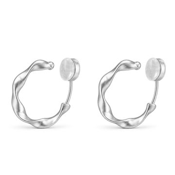 A pair of matte silver organic abstract clip-on hoop earrings with a soft satin finish.