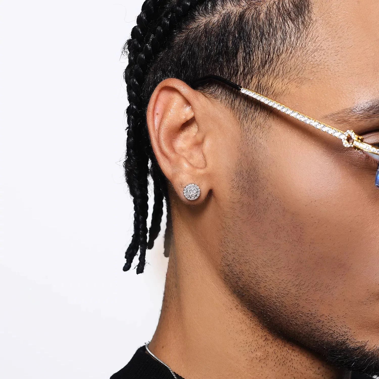 A close-up of a man's ear wearing an iced-out magnetic stud earring, demonstrating its prominent sparkle and comfortable fit on the earlobe.
