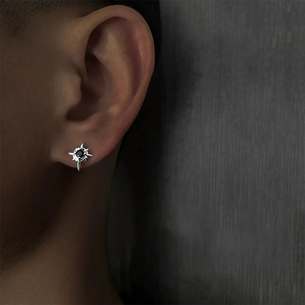 A close-up of a man's ear wearing a Starlight Obsidian magnetic stud earring, showcasing its size and placement on the earlobe.