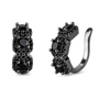 A pair of black huggie hoop earrings with three round black gemstones in prong settings, surrounded by small black pavé accents, shown on a plain white background.