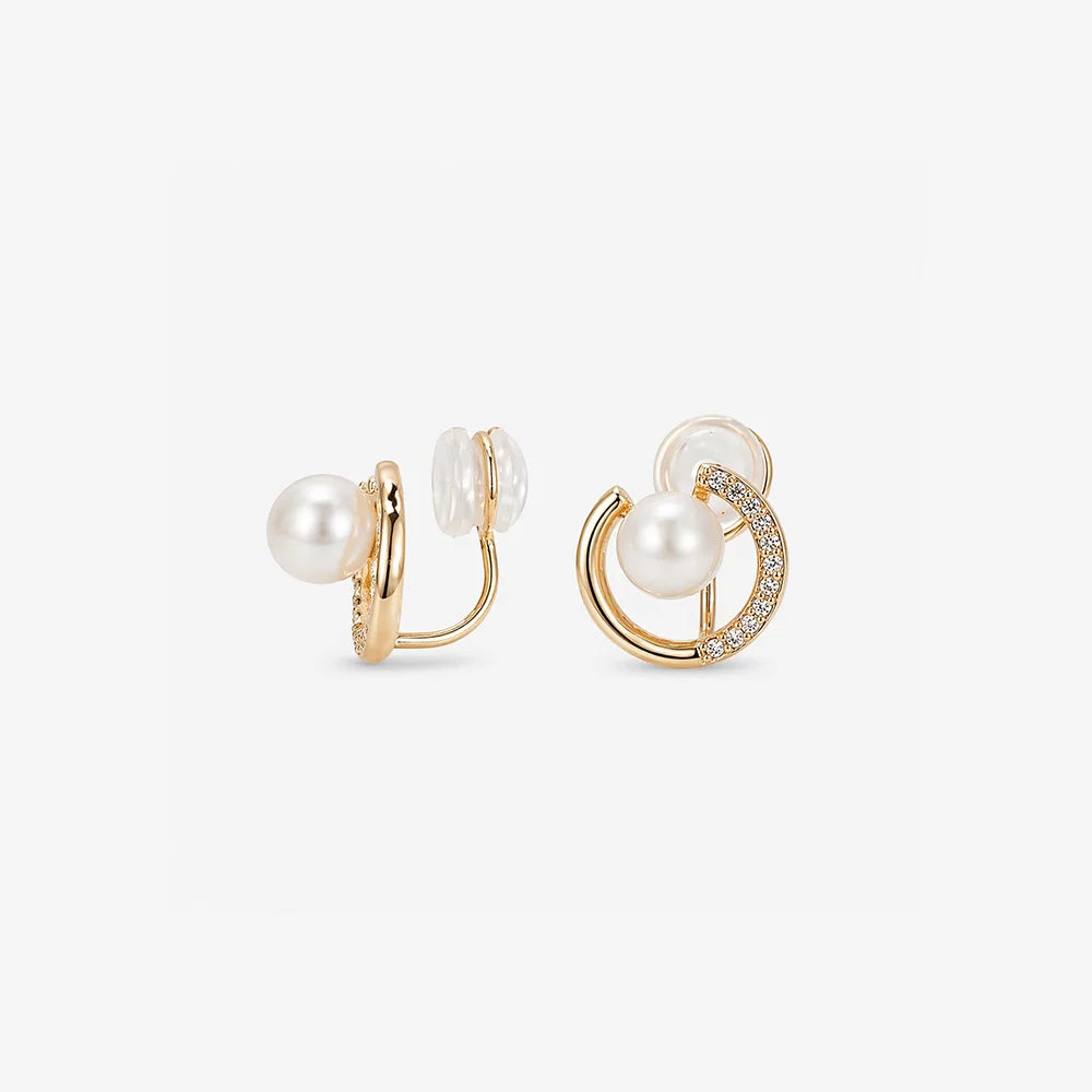 Front and side profile of pearl crescent moon clip on earrings on a clean white background.