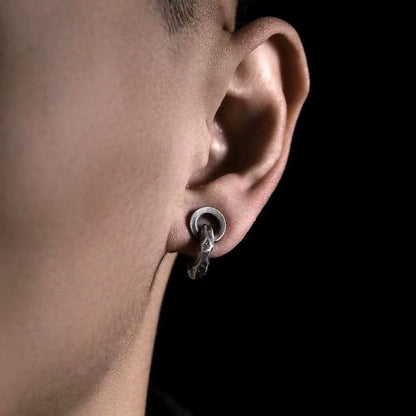 A man wearing the rustic hammered oxidized silver clip-on ear cuff on his lobe or lower helix, demonstrating its fit and style.