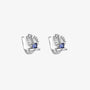 A pair of silver trident clip-on ear cuffs, each adorned with a sapphire blue cubic zirconia and white accent stones, on a white background.